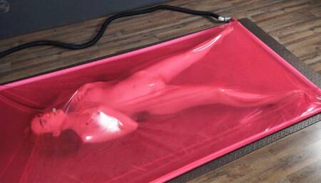 Masturbation in a pink latex vacuum bed