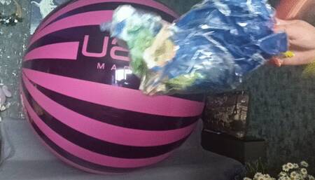 girl blowing globos beachball