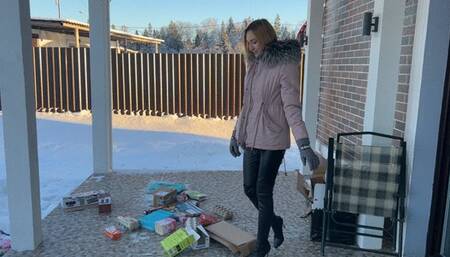 girl in high-heeled boots crushes cardboard and boxes and enjoys it