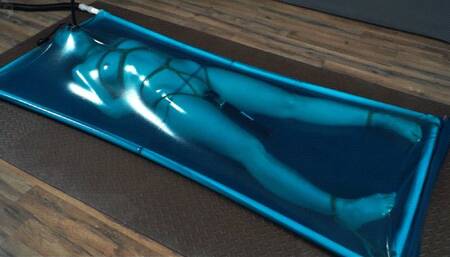 Rope bondage in blue latex bed with vibro and pear gag