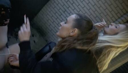 smoking outside in the winter with 1 human forniture to sit on and a human ashtray to use