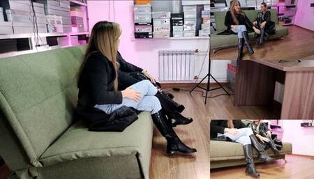 Two long-legged beauties in boots watch the video and discuss it loudly