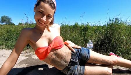 Nastya walks in the fields and gets her belly dirty in the mud