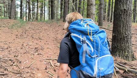 sweaty peeing in the woods with huge backpack