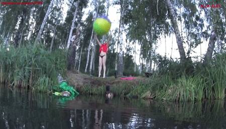 Alla plays with a large beach ball and blows it away while floating on the lake!!!
