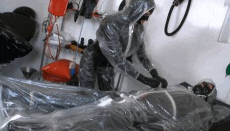 Plastic rubber suit couple and the piss fetish clinic session - Part 2 - First Mouthgag and then plastic cock riding