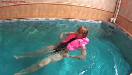 Alla swims in the pool and wears a pink inflatable vest!!!