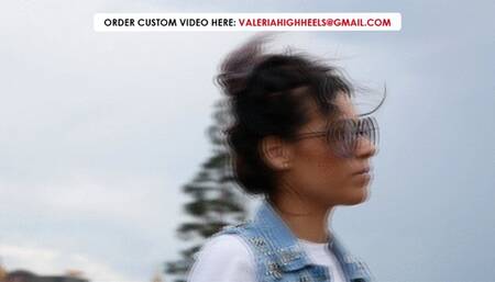 A pretty girl in gold boots walks on dusty dunes