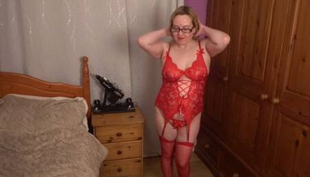 Playing with pussy in red lingerie with red stockings and suspenders