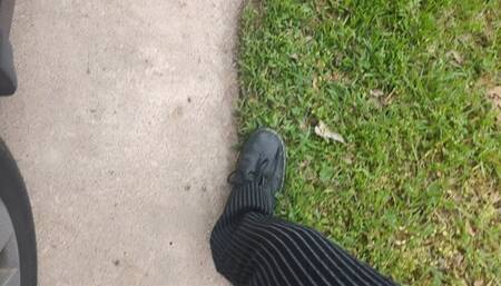 Fifi driving impatiently in Doc Martens boots and pinstripe pants