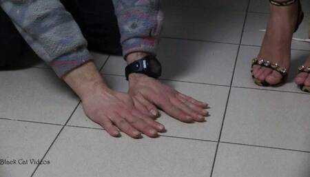 Alice trampling on hands wearing beautiful sandals