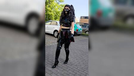 Walking in latex and overknee boots through the city.