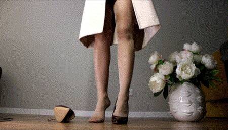 She'll be in a light colored coat and chocolate shoes