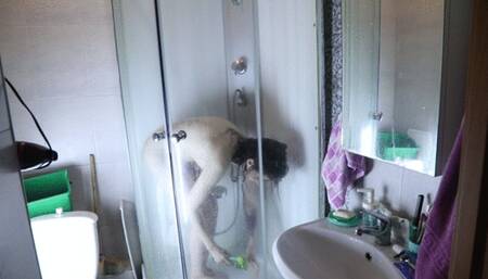A caresses herself in the shower