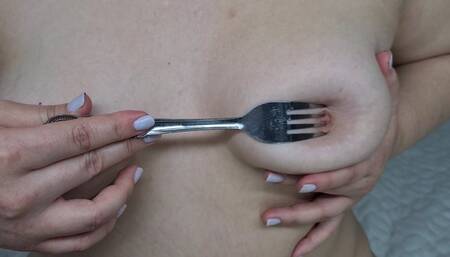 Tit play with a metal fork