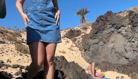 Girl is fingering pussy in front of stranger on the public beach