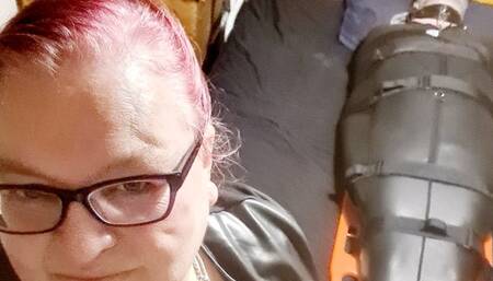 Miss M has her helpless victim in a sleepsack ready for post orgasm blowjob torment