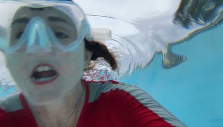 Carissa wearing the red and gray vintage diveskin in the public pool