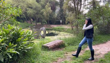 Kahina walks through the forest with her new hunting boots