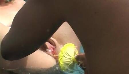 Two hot girls licking in the pool