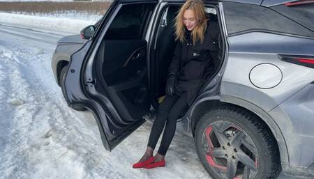 girl in ballet shoes slides on an icy road and loses her ballet shoesE
