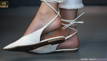 Foot fetish model in a candid feet show, elegant sandals and prefect arched feet, stunning feet close-up