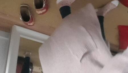 Vacuuming floir and leggings in a cozy jacket and nylon socks