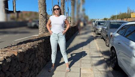 Girl pee in light pants trousers on the public street