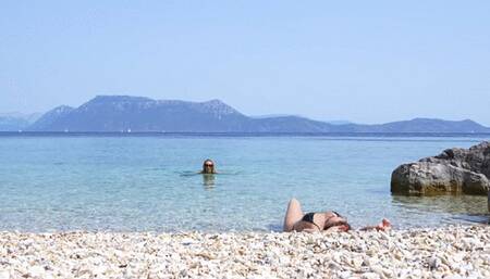 Anita pees standing right on Julia Julia and Anita in Greece on a public beach having fun