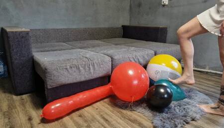 Alina with long toenails and hand nails plays and bursts inflatables