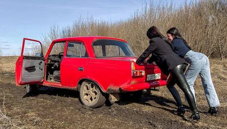 CAR STUCK Two girls in a car stuck in the mud