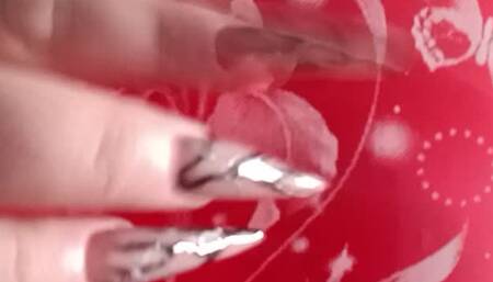 girl in nurse costume blowing red balloon with long nails