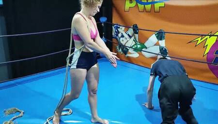 Female wrestler ties up a guy in a ring