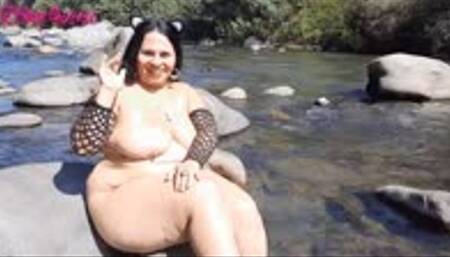 Naked, with cat ears, I masturbate with a giant black dildo in the river