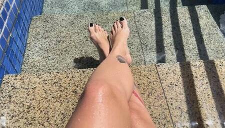 in the pool showing off her beautiful feet
