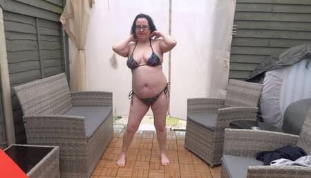 Raven hair wife posing in string bikini