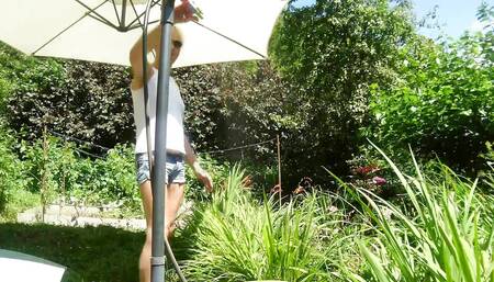 Alexa Cosmic Trans Girl Wetting & Wetlook in the Garden in White T-shirt and Denim Shorts Under Water From a Hose...