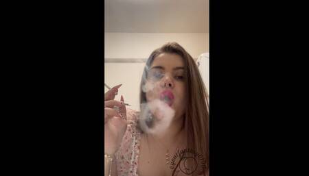 Smoking cigarettes in the kitchen in pink