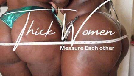 2 Thick women measuring each other