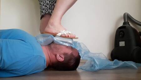 Trampling the air cushions on the slave's face and licking the slippers and toes of his mistress