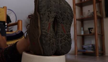 Mature feet in worn tennis shoes and socks