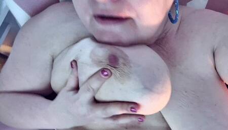Playing with my huge milf tits sucking and licking my nipples