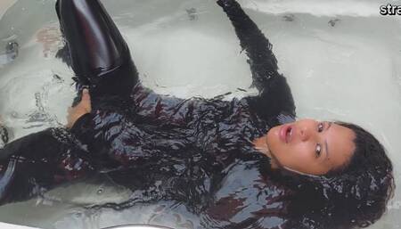 In the bathtub dressed in latex