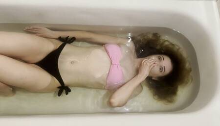 Milana practices breath holding in the bathtub