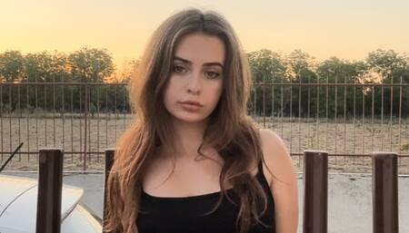 Smoking a cork cigarette in my long black dress before I go out for dinner!