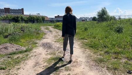 girl accidentally twisted her ankle in the forest and now she needs to jump on one leg so as not to hurt her other, sore leg