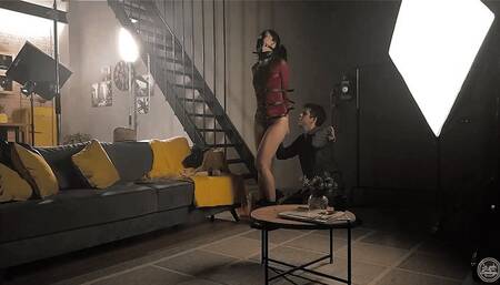 Sage in Chaintrap - Action Begins (Sage Gagged with Panel Gag and Strapped in Harness, Collar and Leggings)