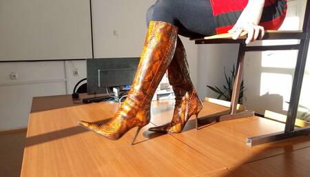 Hot long-legged hottie in high heels dancing on the table