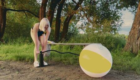 Alla pumps a new beach ball with a hand pump and it bursts loudly