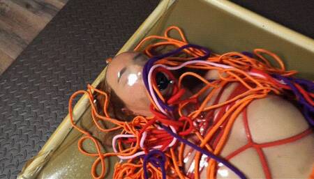 Hard colored bondage with vibro in latex vacuum bed